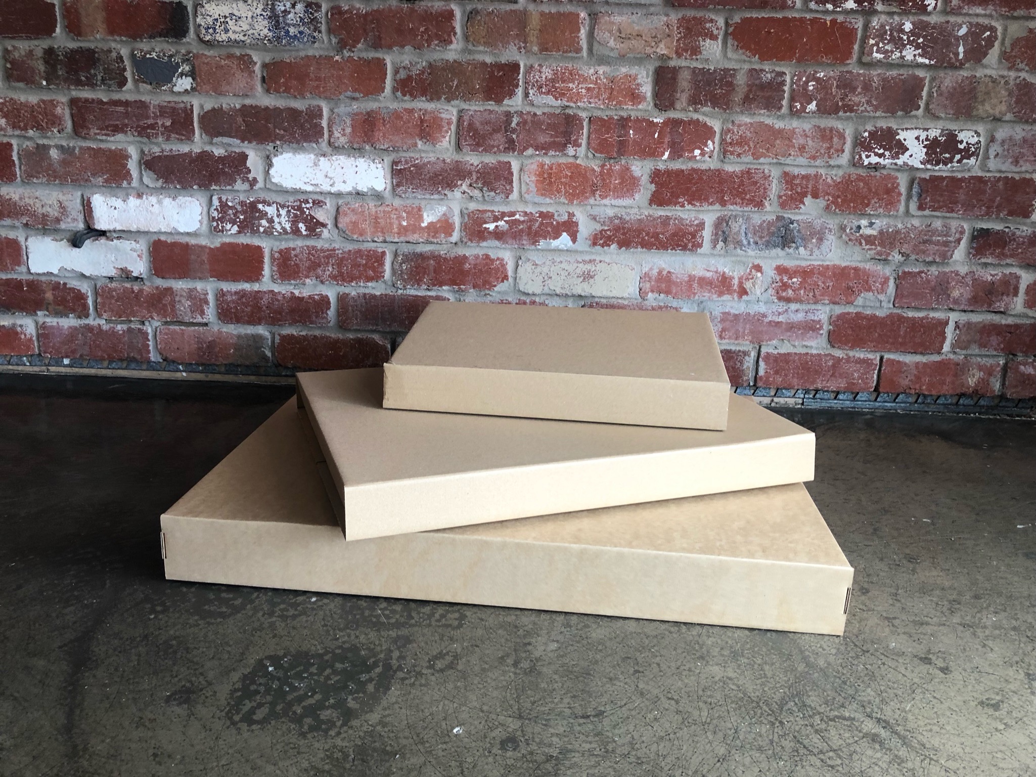 Flat-packed custom cardboard boxes designed for efficient storage and shipping.