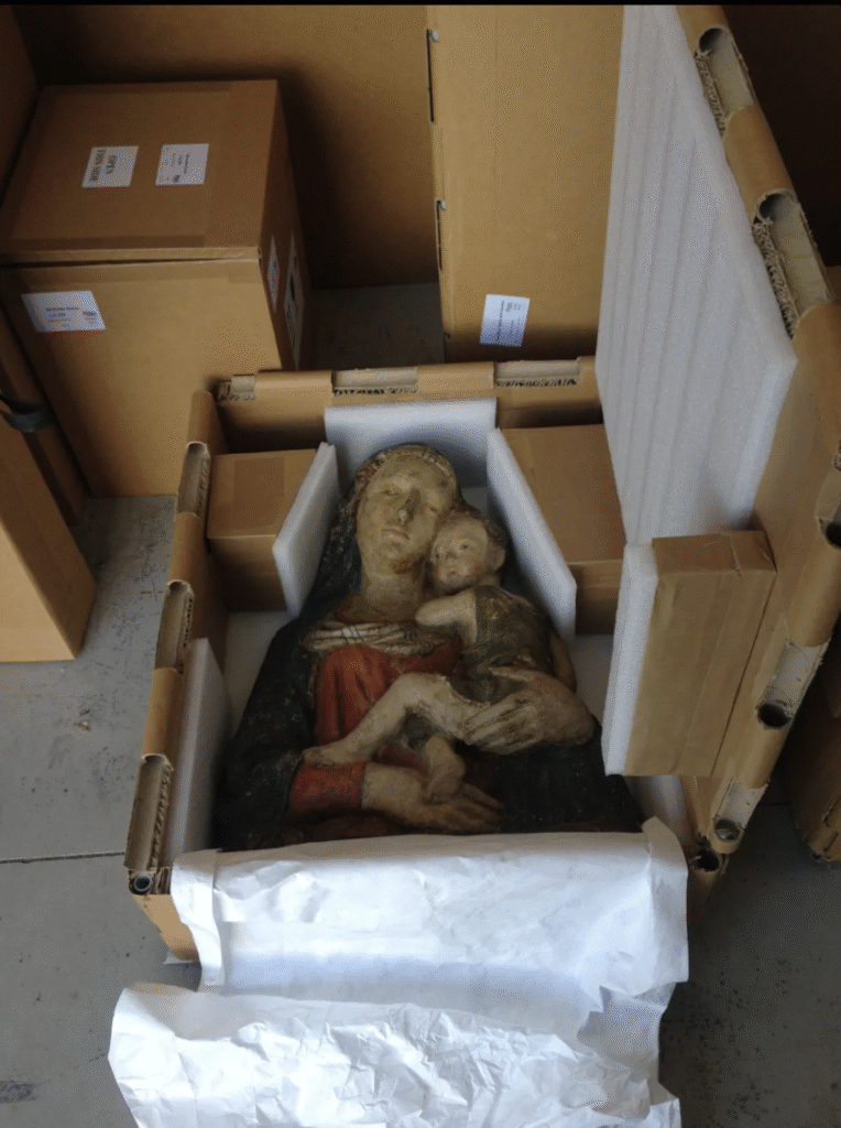 Fragile sculpture securely packed inside a custom Rebul honeycomb crate with foam supports, showing protective packaging for art transport.